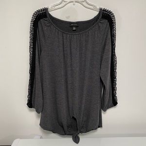 Grey and black top with center bottom knot and long knit style sleeves